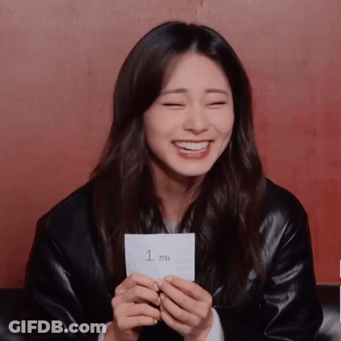A Woman Holds A Piece Of Paper With The Number 1 On It GIF