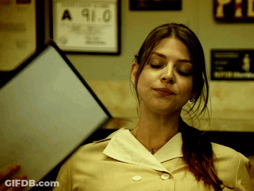 A Woman Holds A Piece Of Paper With The Number 91.0 On It GIF