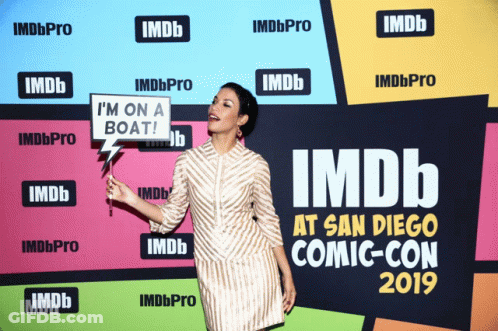 A Woman Holds A Sign That Says " I 'M On A Boat " GIF