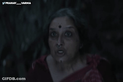 A Woman Holds Her Finger To Her Lips With The Words Pranay_varma Behind Her GIF