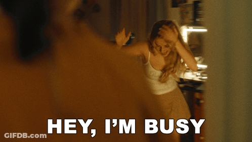 A Woman Holds Her Hand To Her Forehead And Says I 'M Busy GIF
