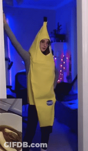 A Woman In A Banana Costume Is Standing In A Doorway With Her Arms Outstretched GIF