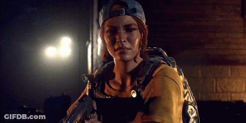 A Woman In A Baseball Cap Is Holding A Gun In Her Hand . GIF