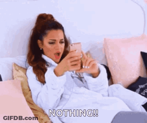 A Woman In A Bathrobe Is Laying On A Bed And Saying Nothing ! GIF