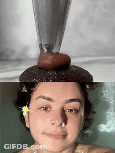 A Woman In A Bathtub With A Glass On Her Head And A Rock On Her Head GIF