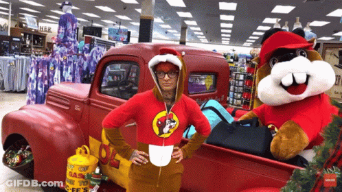A Woman In A Beaver Costume Stands In Front Of A Red Truck With A Propane Tank In The Back GIF