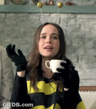 A Woman In A Bee Costume Holds A Cup Of Coffee GIF