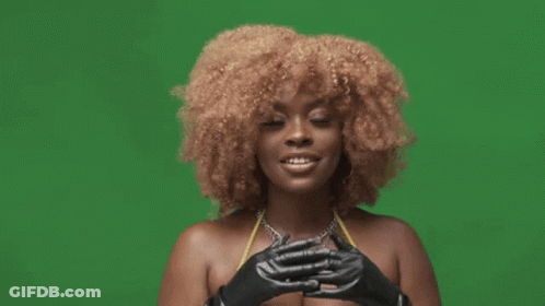 A Woman In A Bikini And Black Gloves Is Making A Funny Face . GIF