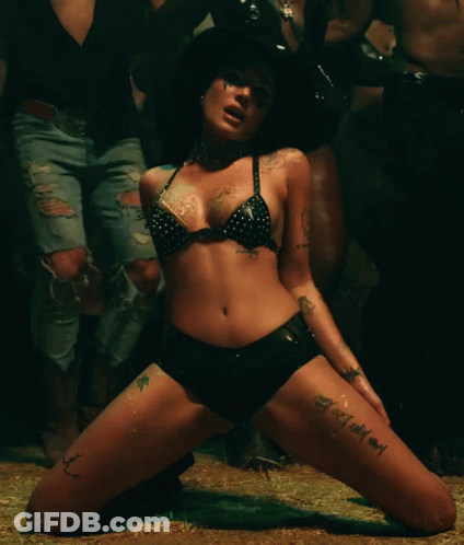A Woman In A Bikini And Shorts Has A Tattoo On Her Leg That Says ' I Love You ' GIF