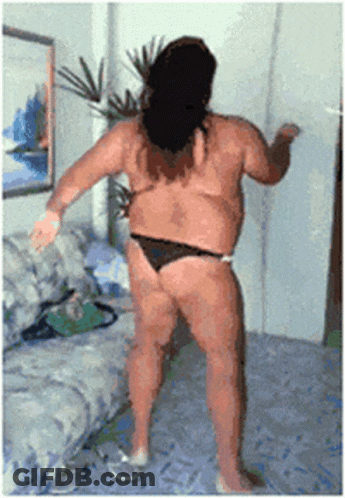 A Woman In A Bikini Is Dancing In A Living Room GIF