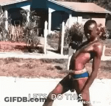 A Woman In A Bikini Is Dancing In Front Of A House And Says Lets Do This GIF