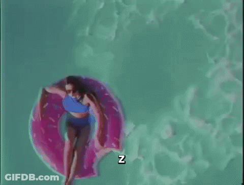 A Woman In A Bikini Is Floating On A Pink Donut Float In A Swimming Pool . GIF