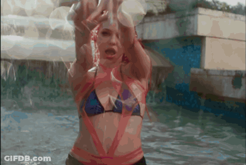 A Woman In A Bikini Is In The Water GIF
