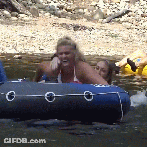 A Woman In A Bikini Sits On A Blue Raft With The Letter O On The Side GIF