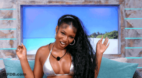 A Woman In A Bikini Sits On A Couch GIF