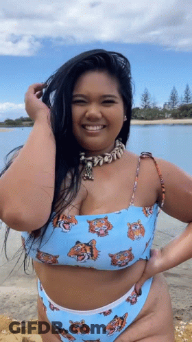 A Woman In A Bikini With Tigers On It GIF