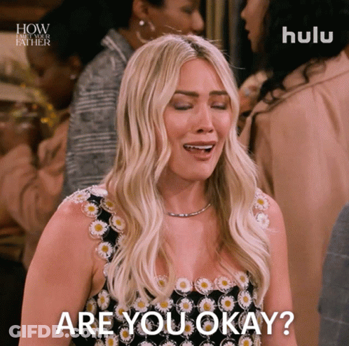 A Woman In A Black And White Dress Is Asking If She Is Okay GIF