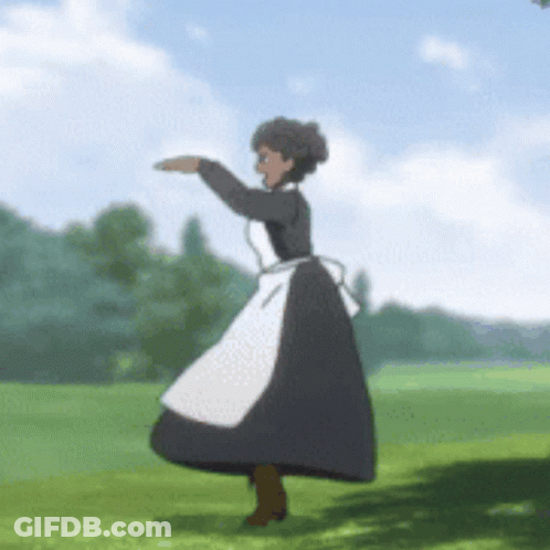 A Woman In A Black And White Dress Is Dancing In A Field GIF