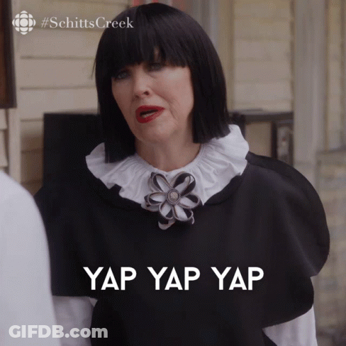 A Woman In A Black And White Outfit Has The Words Yap Yap Yap Written On Her Chest GIF