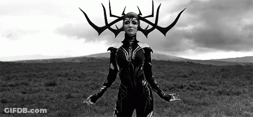 A Woman In A Black And White Photo Is Standing In A Field With Her Arms Outstretched . GIF