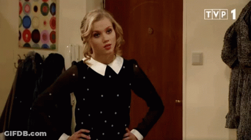 A Woman In A Black And White Polka Dot Dress Is Standing In Front Of A Tvp 1 Logo GIF