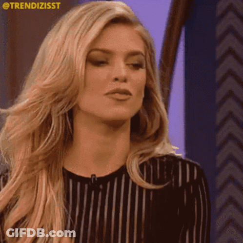 A Woman In A Black And White Striped Shirt Is Clapping Her Hands .. GIF