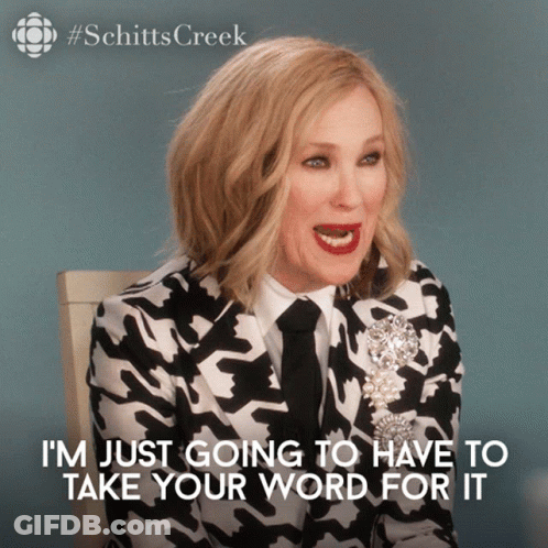 A Woman In A Black And White Suit And Tie Says I 'M Just Going To Have To Take Your Word For It GIF