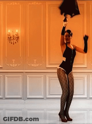 A Woman In A Black Bodysuit Is Dancing In A Room While Holding An Umbrella Over Her Head . GIF
