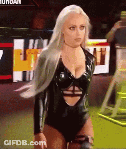 A Woman In A Black Bodysuit Is Standing In Front Of A Sign That Says ' Morgan ' On It GIF