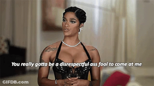 A Woman In A Black Bra And A Necklace Is Talking To Someone . GIF