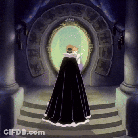A Woman In A Black Cape Stands In Front Of A Mirror With A Crown On Her Head GIF