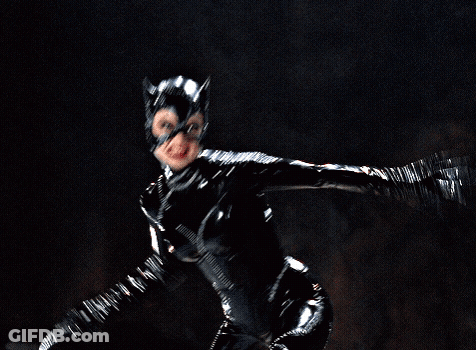 A Woman In A Black Catsuit Is Flying Through The Air GIF