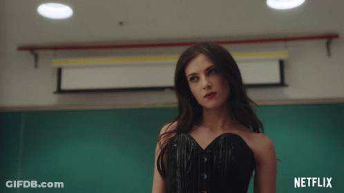 Woman In Black Corset In Front Of Netflix Sign GIF