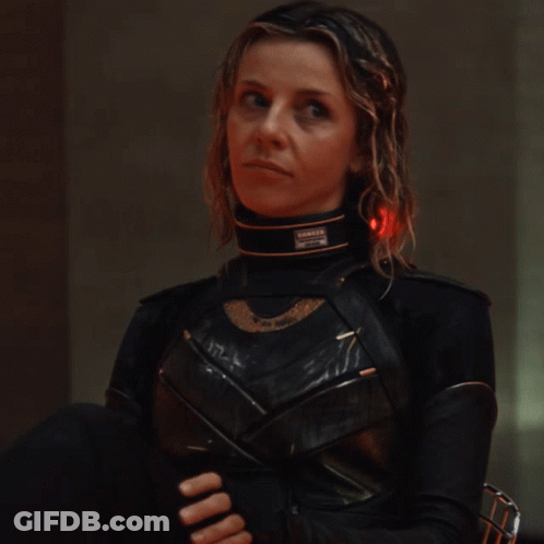 A Woman In A Black Costume Has A Collar That Says ' Danger ' On It GIF