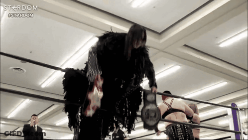 A Woman In A Black Costume Is In A Wrestling Ring Sponsored By Stardom GIF