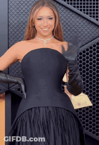 A Woman In A Black Dress And Black Gloves GIF