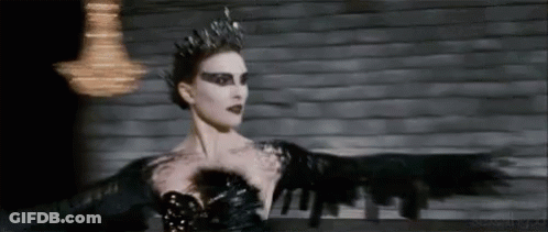 A Woman In A Black Dress And Crown Is Dancing . GIF