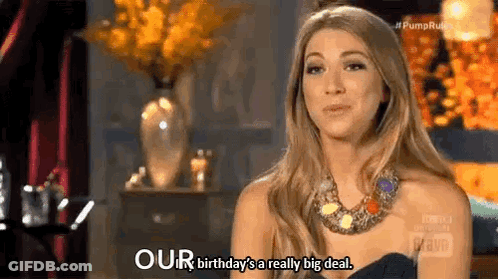A Woman In A Black Dress And Necklace Is Talking About Her Birthday Being A Really Big Deal . GIF