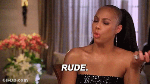 A Woman In A Black Dress Is Blowing A Kiss And Saying " Rude " GIF