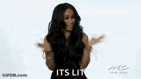 A Woman In A Black Dress Is Dancing With Her Arms Outstretched And Smiling . GIF