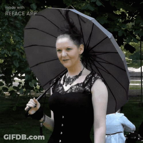 A Woman In A Black Dress Is Holding A Black Umbrella With The Words Made With Reface App On The Bottom GIF