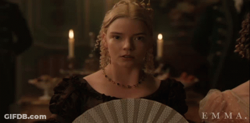 A Woman In A Black Dress Is Holding A Fan And The Name Emma Is On The Bottom GIF