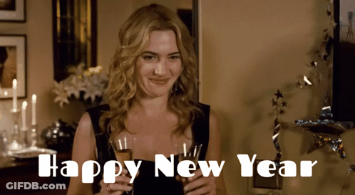 A Woman In A Black Dress Is Holding A Glass Of Champagne With The Words Happy New Year Written Below Her GIF
