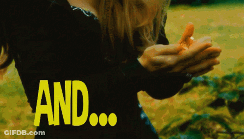 A Woman In A Black Dress Is Holding Something In Her Hands And The Word And Is Visible In Yellow GIF