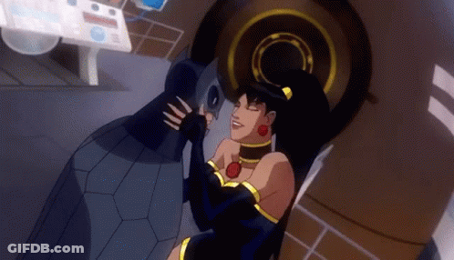 A Woman In A Black Dress Is Kissing A Man In A Black Suit In A Cartoon . GIF