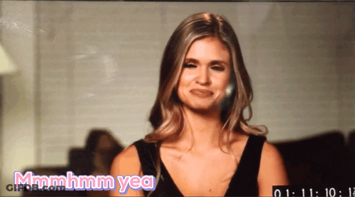 A Woman In A Black Dress Is Making A Funny Face And Says Mmmmhm Yea GIF