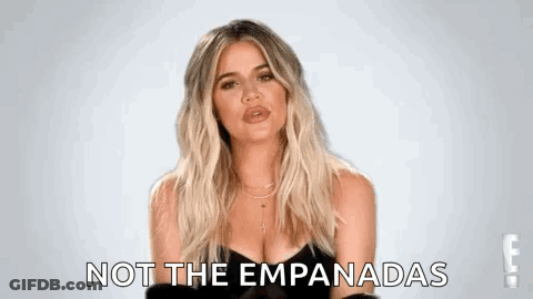 A Woman In A Black Dress Is Making A Funny Face And Says `` Not The Empanadas '' . GIF