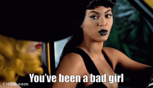 A Woman In A Black Dress Is Sitting In A Car With A Woman In A Yellow Hat . GIF