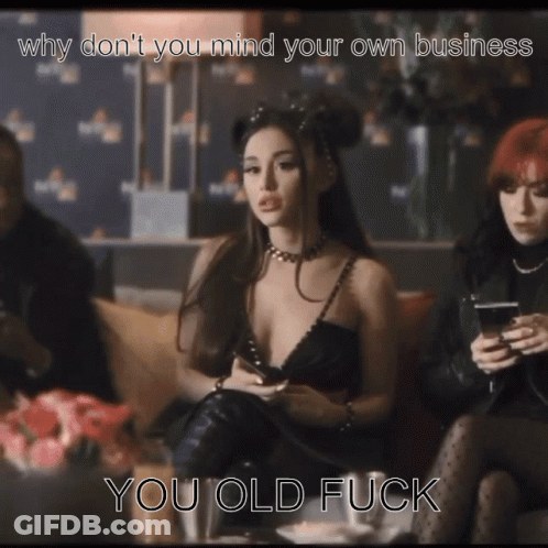 A Woman In A Black Dress Is Sitting On A Couch With The Caption " Why Don T You Mind Your Own Business You Old Fuck GIF