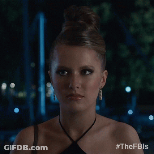 A Woman In A Black Dress Is Smiling And Has The Hashtag #Thefbls On Her Shoulder GIF